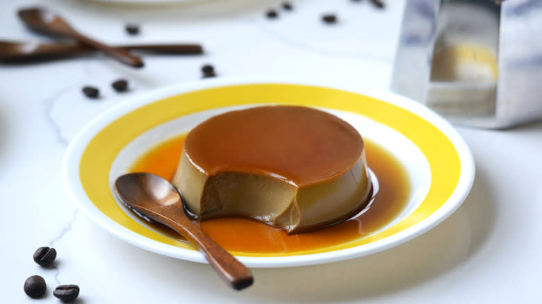Coffee custard pudding with a spoonful taken out of it
