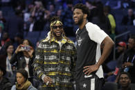 Team Giannis' Joel Embiid, of the Philadelphia 76ers, speaks with Rapper 2 Chainz ahead of the first half of an NBA All-Star basketball game, Sunday, Feb. 17, 2019, in Charlotte, N.C. (AP Photo/Chuck Burton)