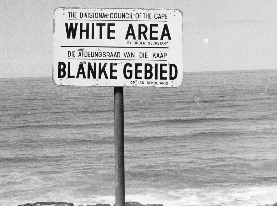 FILE - A sign displayed on a beach in the Western Cape Province reads "White Area" during the apartheid in South Africa on June 23, 1976. Apartheid, imposed in 1948, denied the vote and basic rights to the country's Black majority and other people of color. South Africa is engrossed in debate over the legacy of apartheid's last president, de Klerk, who died at 85 and is to be buried Sunday, Nov 21, 2021. (AP Photo/File)