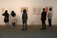 Visitors look at artworks by the American artist Sol Lewitt while visiting a 19th and 20th-century American and European minimalist and conceptual masterpieces show at the Tehran Museum of Contemporary Art in Tehran, Iran, Tuesday, Aug. 2, 2022. Some of the world’s most prized works of contemporary Western art have been unveiled for the first time in decades — in Tehran. (AP Photo/Vahid Salemi)