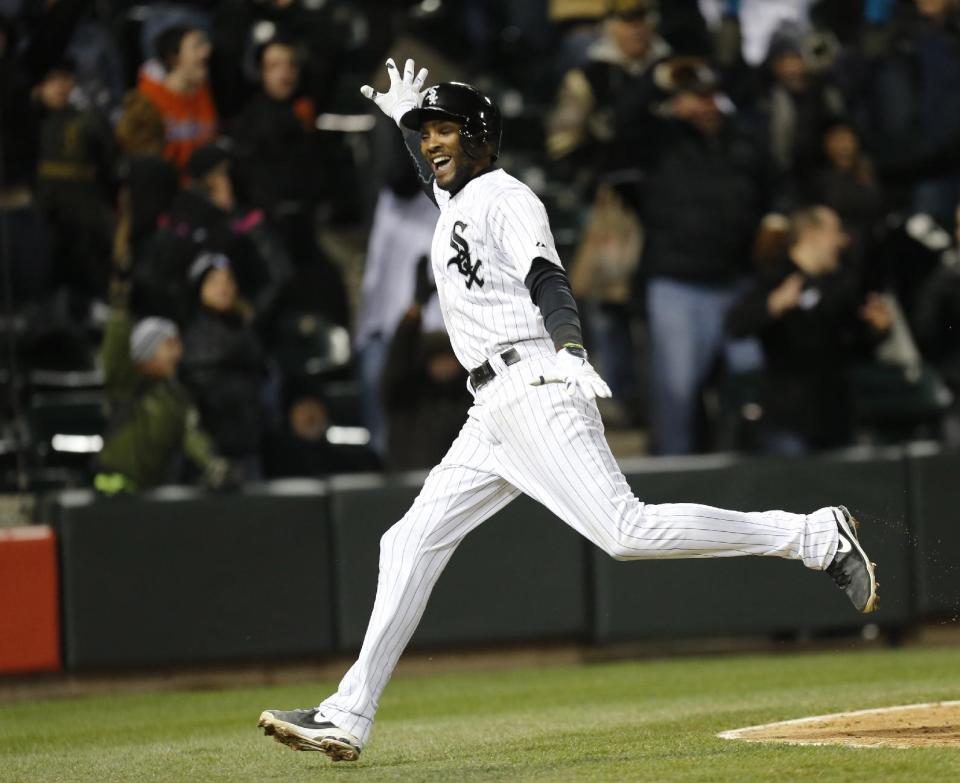 Chicago White Sox's Alexei Ramirez celebrates after scoring the game-winning run off a throwing error by Boston Red Sox shortstop Xander Bogaerts during the ninth inning of a baseball game Tuesday, April 15, 2014, in Chicago. Chicago won 2-1. (AP Photo/Charles Rex Arbogast)