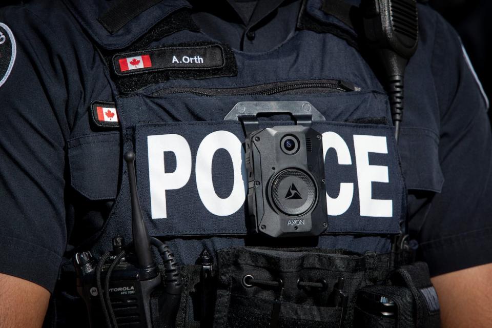 A photo of a Toronto police officer wearing a body camera. Renfrew, Ont. is considering giving its only bylaw officer a body camera to promote accountability and improve the officer's safety. (Evan Mitsui/CBC - image credit)