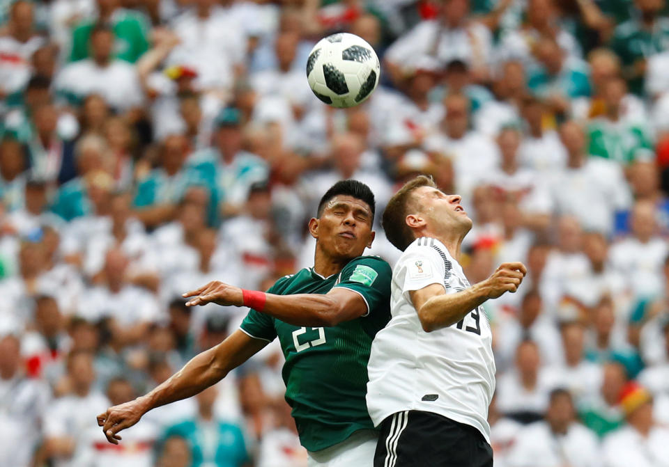 <p>Thomas Muller goes up for a header with Mexico’s Jesus Gallardo </p>