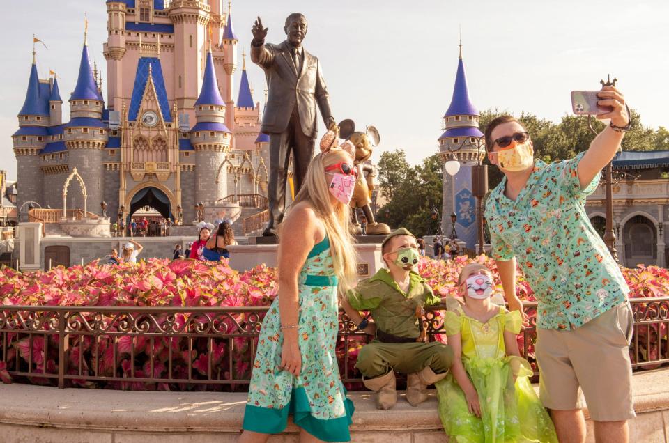 Guests stop to take a selfie at Magic Kingdom Park at Walt Disney World Resort