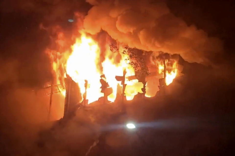 In this image taken from video by Taiwan's EBC, fire and smoke pour out from a building in Kaohsiung, in southern Taiwan on Thursday, Oct. 14, 2021. The fire engulfed a 13-story building overnight in southern Taiwan, the island's semi-official Central News Agency reported Thursday. (EBC via AP )