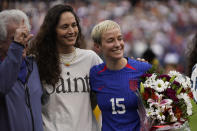 United States forward Megan Rapinoe, right, stands with her fiancee Sue Bird before a soccer game against South Africa Sunday, Sept. 24, 2023, in Chicago. (AP Photo/Erin Hooley)