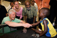 Former President Clinton and Haitian President René Préval spend time with a child while visiting an emergency hospital in Gonaïves, Haiti, in July 2009. President Clinton formed the Clinton Foundation Haiti Fund following the devastating earthquake that struck Haiti in January 2010. More than 100,000 individuals donated more than $16.4 million to the Fund. (UN Photo/Marco Dormino)