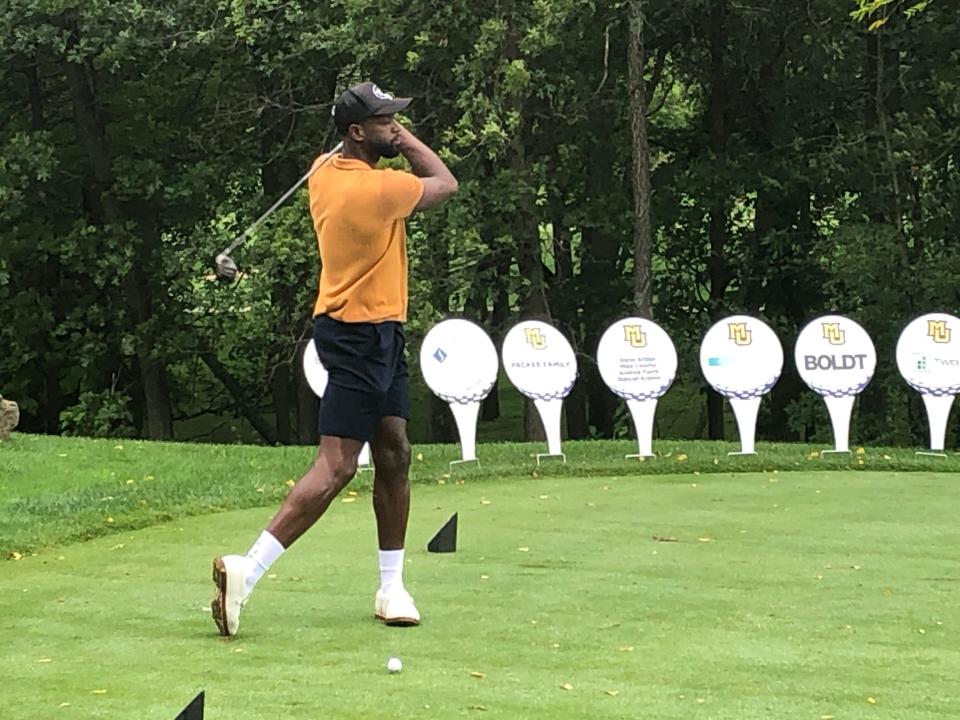 Former Marquette star Dwyane Wade gets ready to tee off during a reunion of the 2003 Final Four team on Monday at The Legend at Brandybrook.