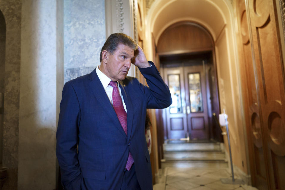 Sen. Joe Manchin, D-W.Va., a key negotiator in the bipartisan infrastructure agreement, stands outside the chamber as the Senate advances the roughly $1 trillion infrastructure plan at the Capitol in Washington, Friday, July 30, 2021. (AP Photo/J. Scott Applewhite)