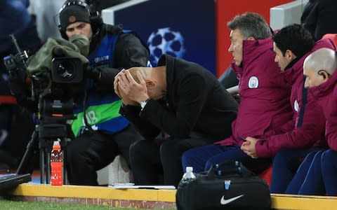 A dejected Man City manager Pep Guardiola reacts, head in hands during the UEFA Champions League Quarter Final First Leg match between Liverpool and Manchester City at Anfield - Credit: Getty images