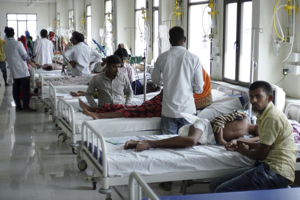 In this Sept. 12, 2019, photo, patients are treated inside the encephalitis ward in Baba Raghav Das Medical College hospital in Gorakhpur, India. Cases of encephalitis, or inflammation of the brain, in Uttar Pradesh, India's most populated state with millions of rural poor, have dropped sharply. Doctors and state government officials credit a new network of rural clinics and a massive immunization and cleanliness drive in seven districts with the highest caseloads of the disease that's often deadly. An independent physician says there's no way to independently verify the government's claims, but that a decline is visible. (AP Photo/Usman Ahmad)