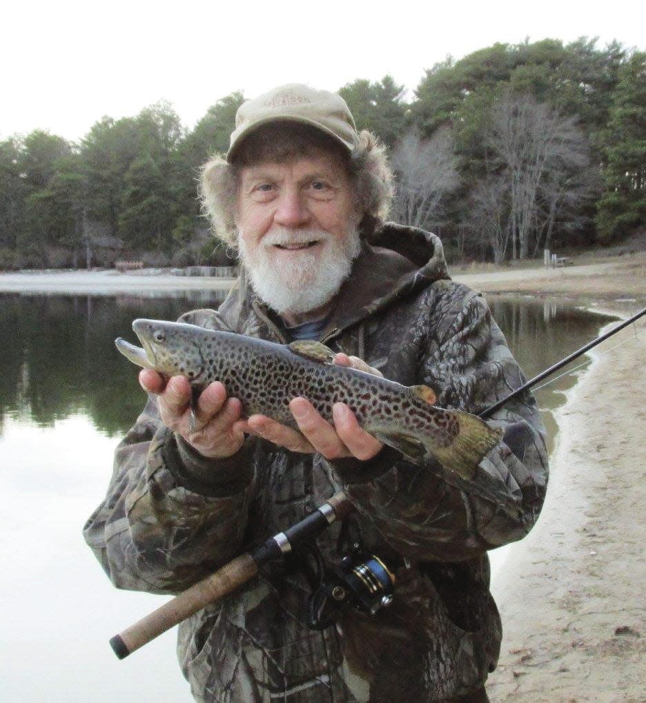 Randy Julius, of East Bridgewater, holds a brown trout, he caught at Fearing Pond in Myles Standish State Forest in Plymouth on Easter Sunday in 2019.