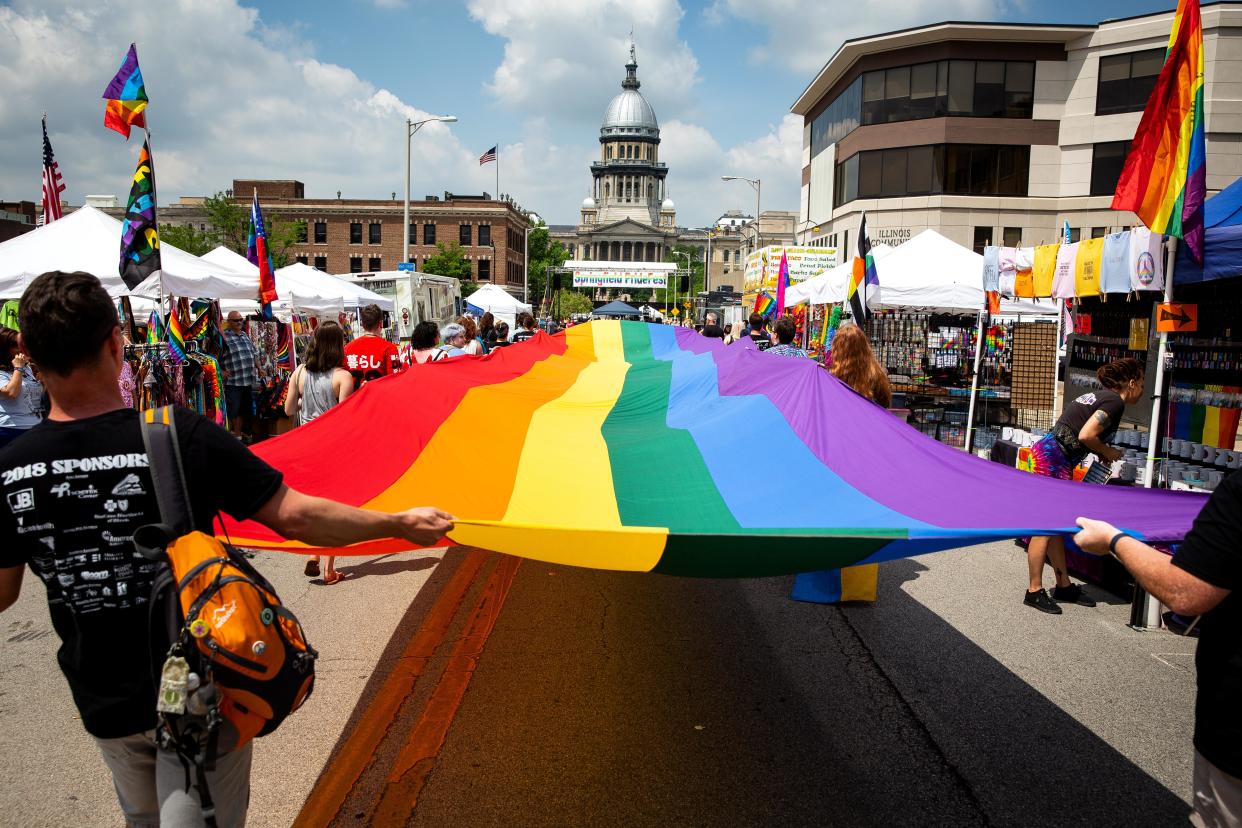 A rainbow flag carried by staff and volunteers from the Phoenix Center during the Springfield PrideFest parade, makes its way down Capitol Avenue Saturday, May 19, 2018 in Springfield, Ill.