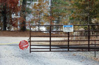 A gate blocks the road leading to the West End Substation, at 6910 NC Hwy 211 in West End, N.C., Monday, Dec. 5, 2022, where a serious attack on critical infrastructure has caused a power outage to many around Southern Pines, N.C. (AP Photo/Karl B DeBlaker)