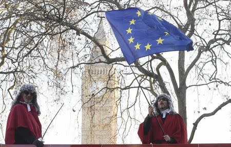 Protesters wearing judges' wigs and robes ride an open top bus past the Supreme Court ahead of the challenge against a court ruling that Theresa May's government requires parliamentary approval to start the process of leaving the European Union, in Parliament Square, central London, Britain December 5, 2016. REUTERS/Toby Melville