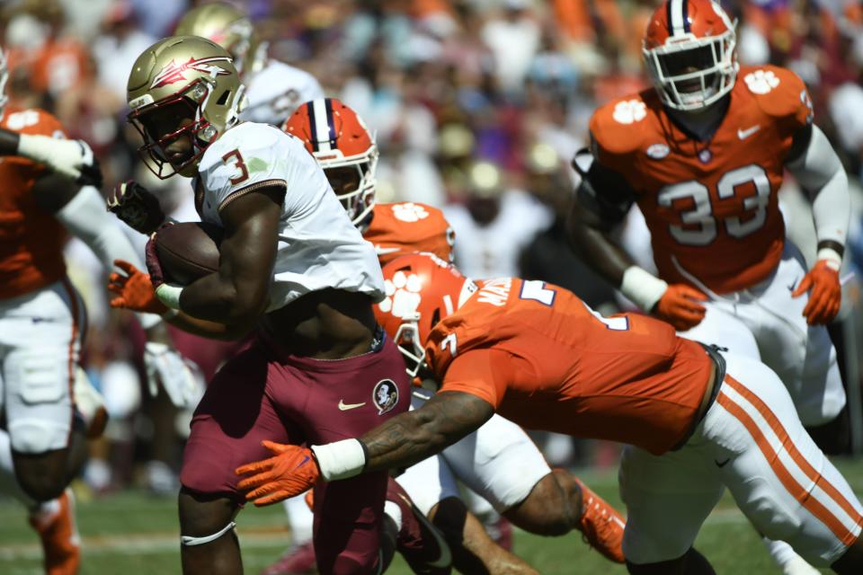 Florida State University running back Trey Benson (3) is tackled by Clemson defensive end Justin Mascoll (7) on Sep 23, 2023; Clemson, South Carolina, USA; at Memorial Stadium.