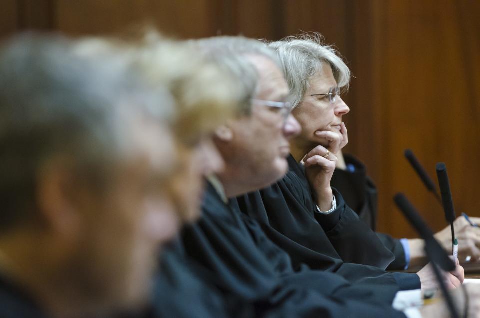 Vermont Supreme Court Associate Justice Beth Robinson (right) listens in Montpelier on Thursday, Dec. 5, 2013, to arguments in a case brought by George Maille who lives near the Burlington International Airport in South Burlington. Maille objected to the Development Review Board's decision to permit the destruction of 54 vacant homes near the airport.