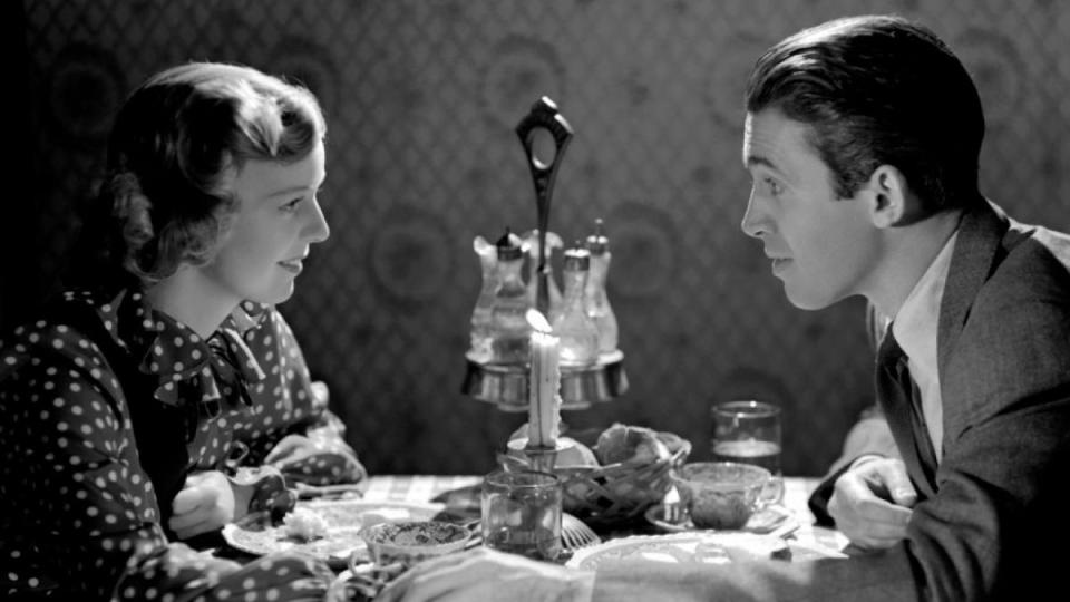 Man and woman holding hands over a table in “The Shop Around the Corner”