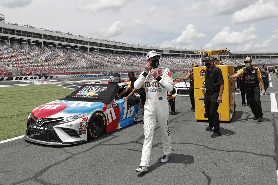 Driver Kyle Busch walks along pit road during qualifying for a NASCAR Cup Series auto race at Charlotte Motor Speedway Sunday, May 24, 2020, in Concord, N.C. (AP Photo/Gerry Broome)