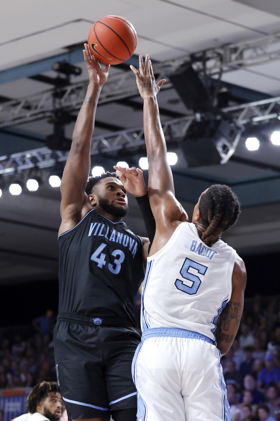 In a photo provided by Bahamas Visual Services, Villanova's Eric Dixon shoots over North Carolina's Armando Bacot during an NCAA college basketball game in the Battle 4 Atlantis at Paradise Island, Bahamas, Thursday, Nov. 23, 2023. (Tim Aylen/Bahamas Visual Services via AP)