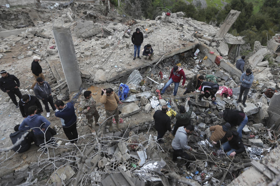 People search for victims in the rubble of a paramedic center that was destroyed by an Israeli airstrike early Wednesday in Hebbariye village, south Lebanon, Wednesday, March 27, 2024. The Israeli airstrike on a paramedic center linked to a Lebanese Sunni Muslim group killed several people of its members. The strike was one of the deadliest single attacks since violence erupted along the Lebanon-Israel border more than five months ago. (AP Photo/Mohammed Zaatari)