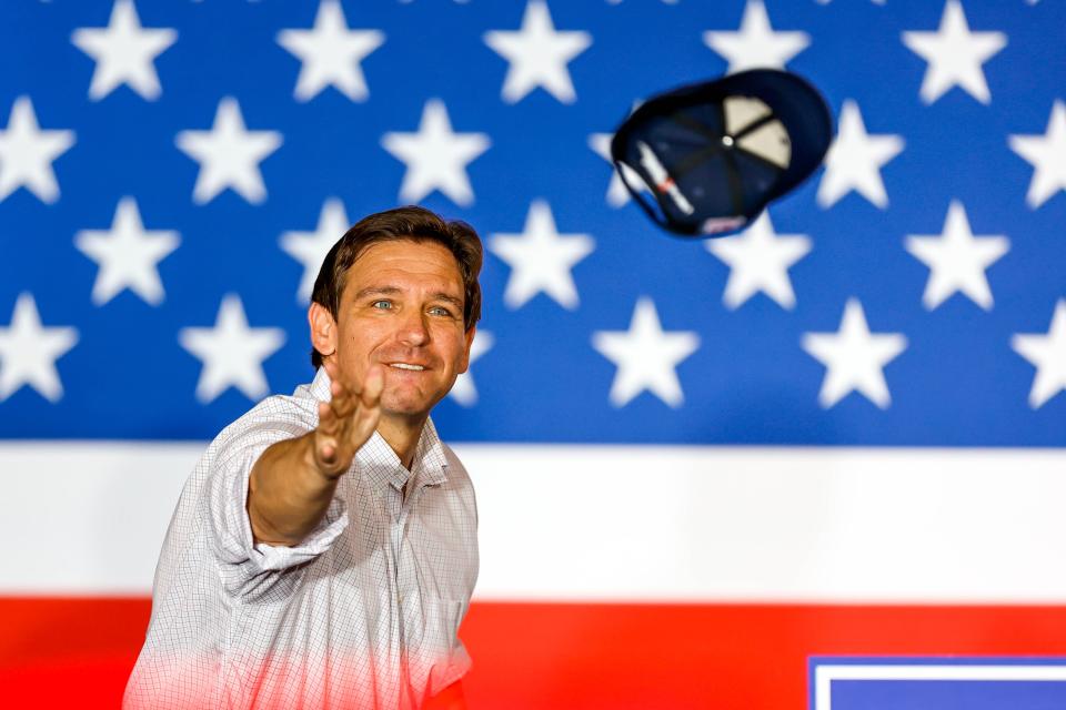 Florida Gov Ron DeSantis throws hats to the crowd at an event held by the Never Back Down PAC featuring presidential candidate DeSantis in Tulsa, Okla., on Saturday, June 10, 2023.