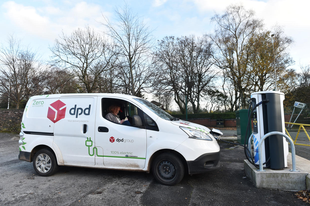 A DPD worker is seen waiting for her electric vehicle to get charged at a pod point in Stoke-On-Trent, England. Photo: Nathan Stirk/Getty Images