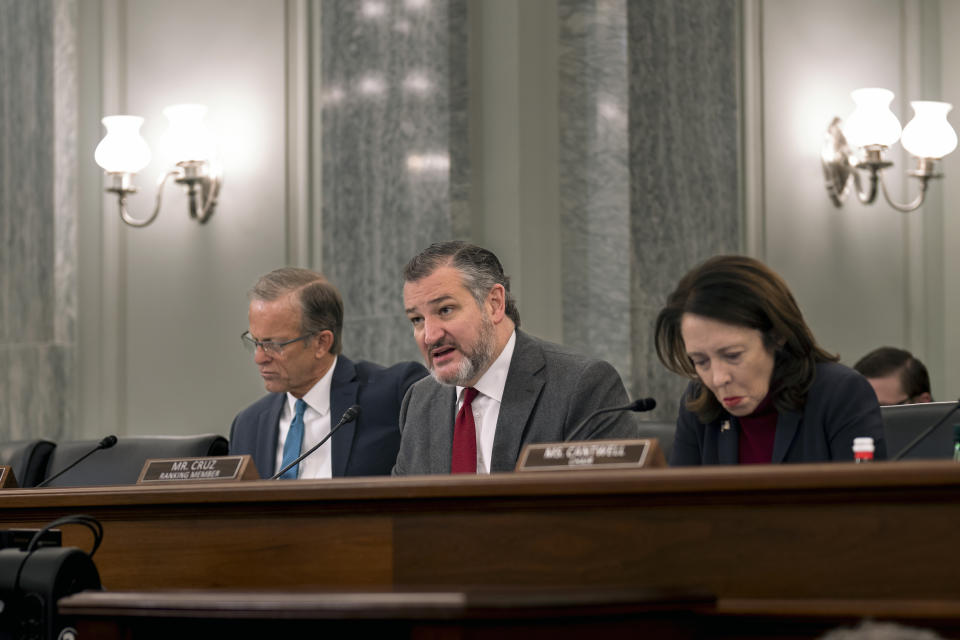 Sen. Ted Cruz, R-Texas, center, the ranking member of the Senate Commerce, Science, and Transportation Committee, is flanked by Sen. John Thune, R-S.D., left, and by Chair Maria Cantwell, D-Wash., questions Acting Administrator of the Federal Aviation Administration Billy Nolen as the panel examines recent failures in the FAA's NOTAM system, at the Capitol in Washington, Wednesday, Feb. 15, 2023. (AP Photo/J. Scott Applewhite)