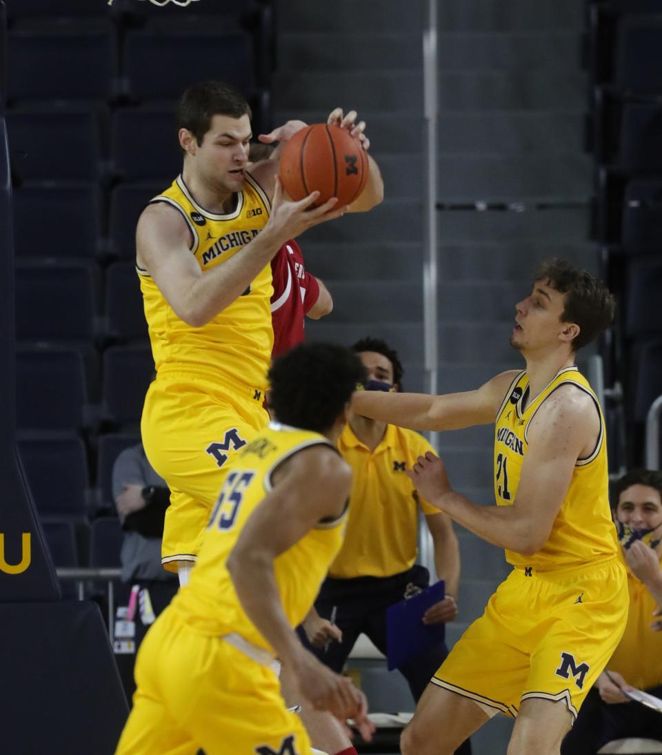 Michigan center Hunter Dickinson rebounds against Wisconsin during the first half at Crisler Center on Tuesday, Jan. 12, 2021.