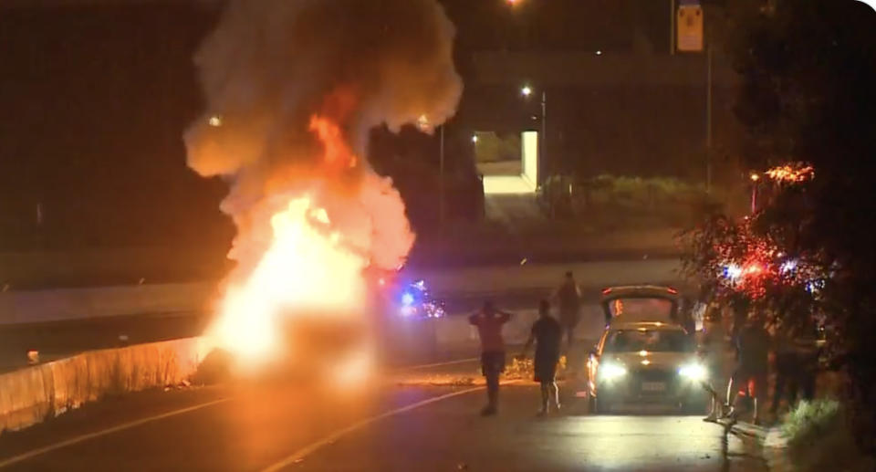 The car on fire on the M4 in Homebush.