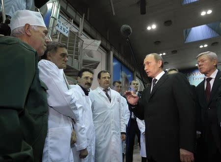 Russia's then Prime Minister Vladimir Putin (2nd R) speaks as he visits the state-run Energomash company outside Moscow in this November 30, 2009 file photo. REUTERS/RIA Novosti/Pool/Alexei Nikolsky/Files