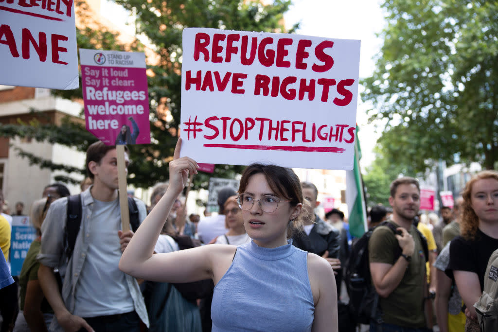 A protester holds a placard expressing her opinion during