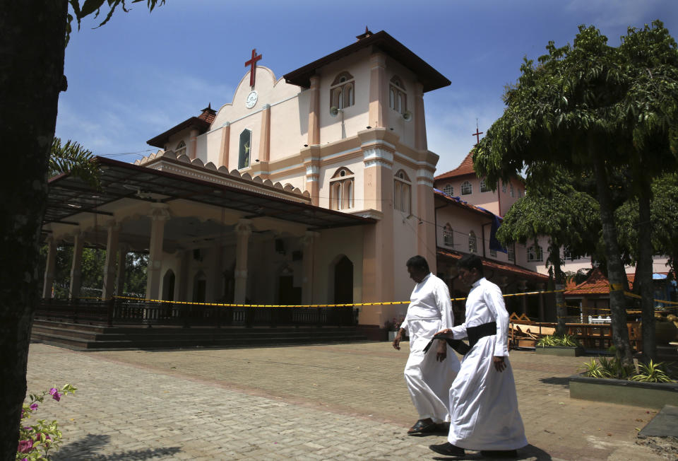 Sri Lankan Roman Catholic priests walk past damaged St. Sebastian's Church in Katuwapitiya village in Negombo, north of Colombo, Sri Lanka, Thursday, April 25, 2019. Christians in Sri Lanka belong to both its main ethnic groups, and that rare inclusiveness of a small religious minority may explain the measured calm that’s been the response so far to the Easter attacks. But there’s widespread fear that more attacks could plunge Sri Lanka into the cycle of violence and retaliation that marked the bloody civil war that ended a decade ago. (AP Photo/Manish Swarup)