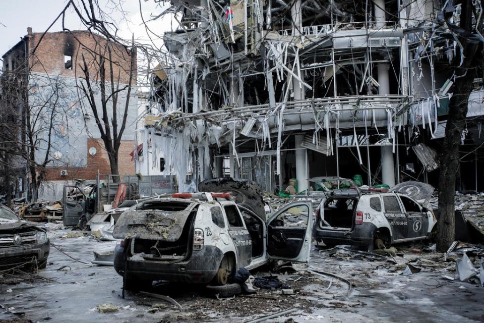 Damaged vehicles sit among debris and in Kharkiv city centre in Ukraine, Wednesday (AP)