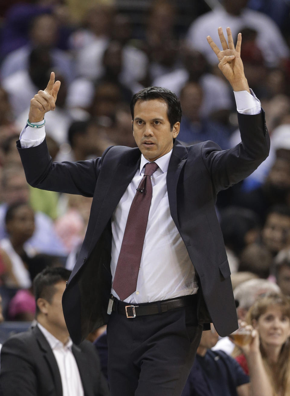 Miami Heat coach Erik Spoelstra gestures to his players during the first half against the Charlotte Bobcats in Game 4 of an opening-round NBA basketball playoff series in Charlotte, N.C., Monday, April 28, 2014. (AP Photo/Chuck Burton)