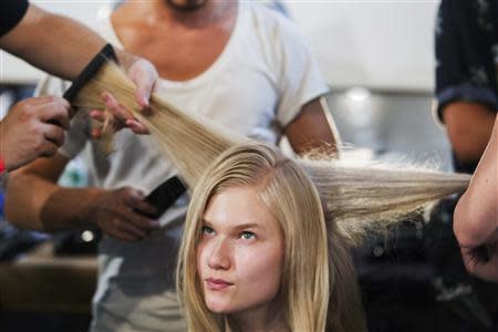 A model has her hair done backstage before a presentation of the Honor Spring/Summer 2014 collection during New York Fashion Week, September 5, 2013. REUTERS/Lucas Jackson