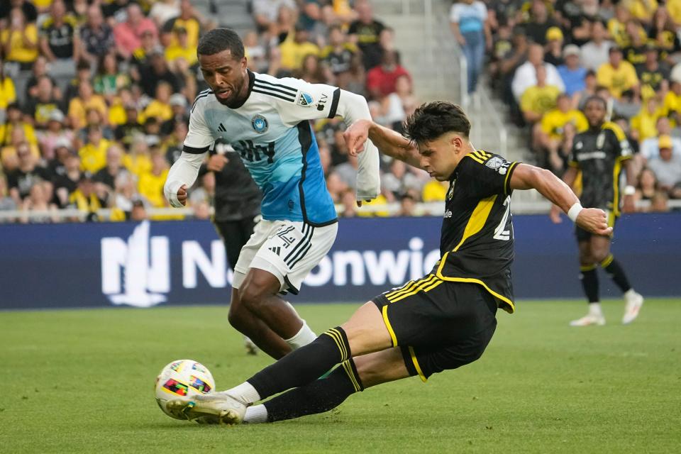 Crew forward Max Arftsen shoots past Charlotte FC defender Nathan Byrne on July 17.