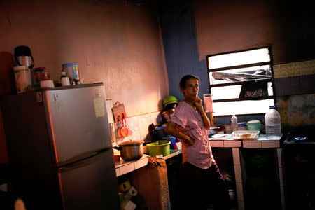 Yaneidi Guzman, 38, stands in her kitchen at home in Caracas, Venezuela, March 20, 2018. REUTERS/Carlos Garcia Rawlins