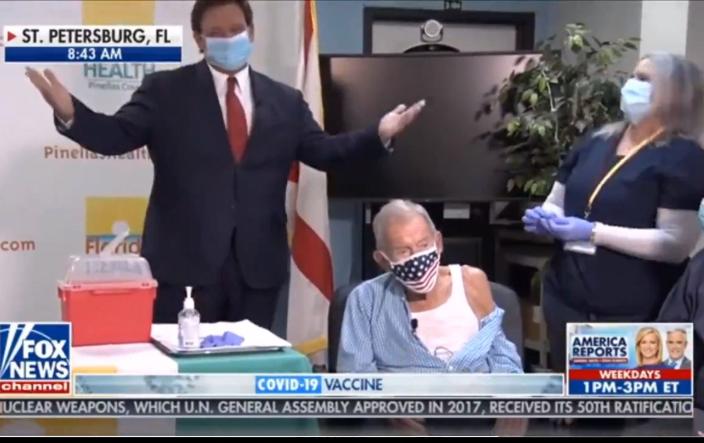 In this screenshot, Florida Gov. Ron DeSantis appears on Fox &amp; Friends chaperoning 100-year-old Henry Sayler as he gets what DeSantis said may be the millionth senior COVID-19 vaccination in the state.