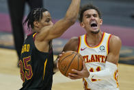 Atlanta Hawks' Trae Young (11) drives to the basket against Cleveland Cavaliers' Isaac Okoro (35) in the second half of an NBA basketball game, Tuesday, Feb. 23, 2021, in Cleveland. The Cavaliers won 112-111. (AP Photo/Tony Dejak)