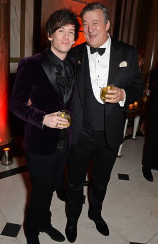 <p>David M. Benett/Getty</p> Elliott Spencer and Stephen Fry and in 2015