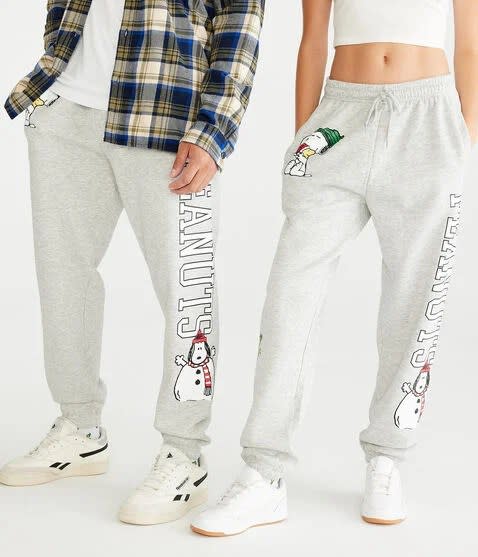 models in gray sweatpants that say "peanuts" with snoopy as a snowman graphic