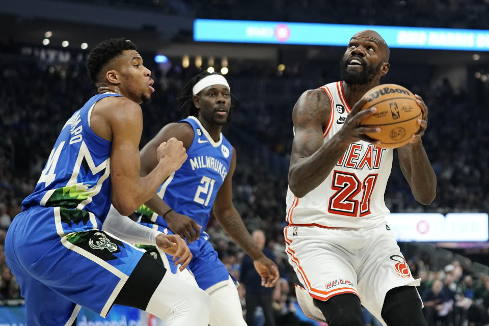 Miami Heat's Dewayne Dedmon (21) looks to shoot against Milwaukee Bucks' Giannis Antetokounmpo during the first half of an NBA basketball game Saturday, Feb. 4, 2023, in Milwaukee. (AP Photo/Aaron Gash)