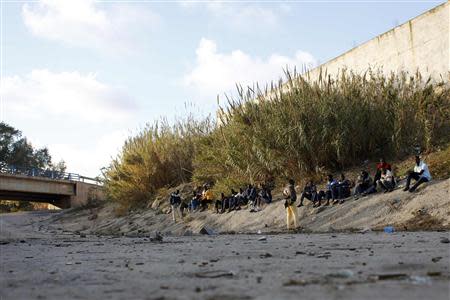 African immigrants from Mali pass the time in Spain's north African enclave Melilla December 8, 2013. REUTERS/Juan Medina