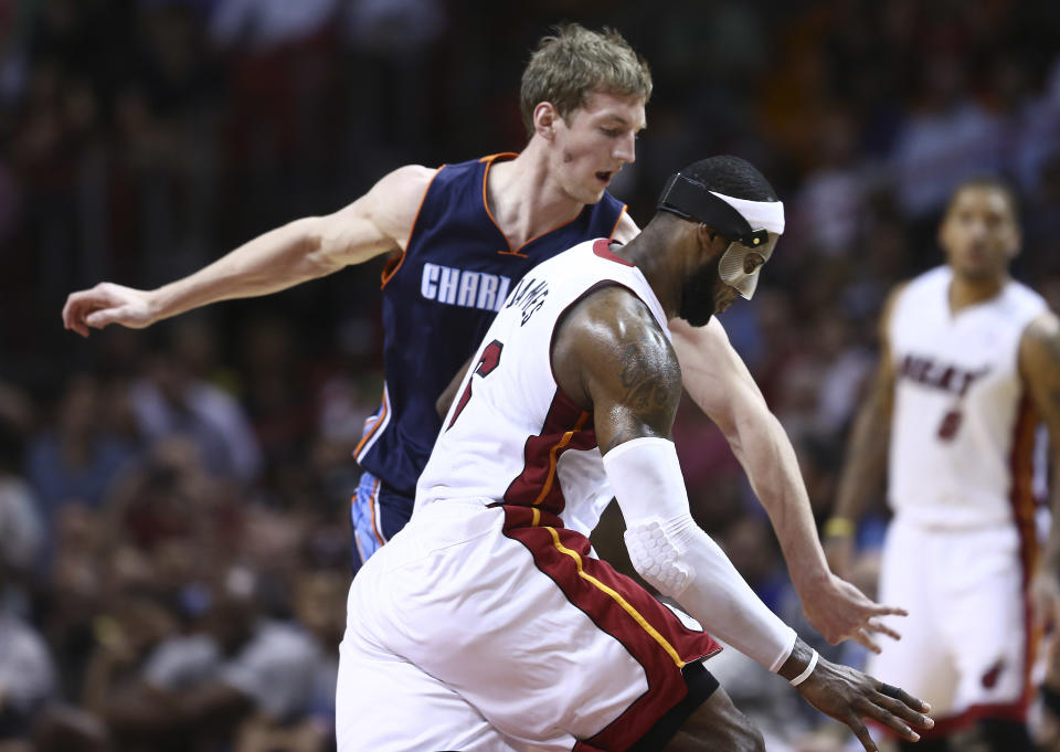 Charlotte Bobcats' Cody Zeller (40) tries to block Miami Heat's LeBron James (6) during the second half of an NBA basketball game in Miami, Monday, March 3, 2014. James scored a team record of 61 points. The Heat won 124-107. (AP Photo/J Pat Carter)