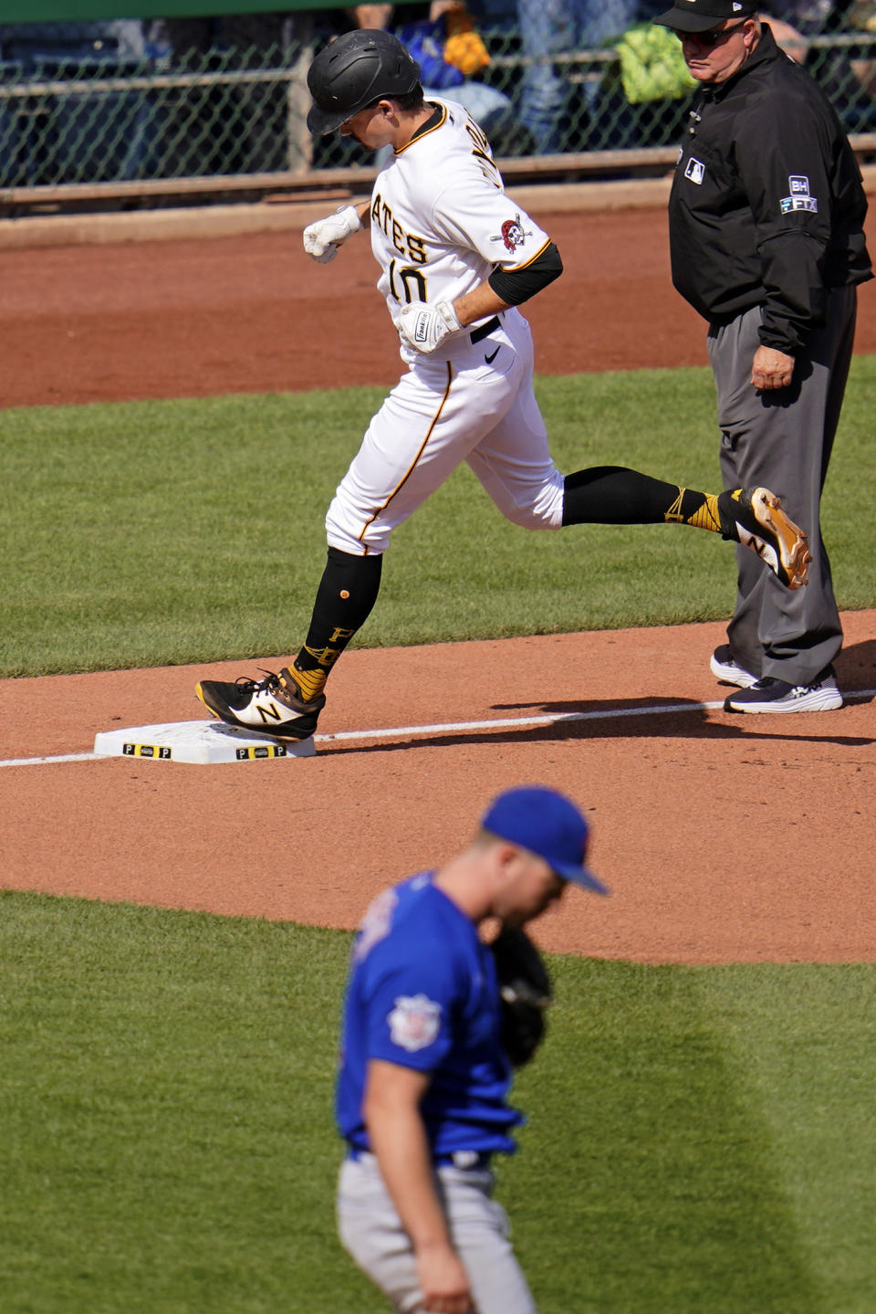 Pittsburgh Pirates' Bryan Reynolds (10) rounds third after hitting a solo home run off Chicago Cubs starting pitcher Adrian Sampson, bottom, during the sixth inning of a baseball game in Pittsburgh, Sunday, Sept. 25, 2022. (AP Photo/Gene J. Puskar)
