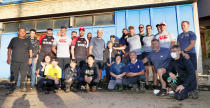 In this Oct. 13, 2019, photo, Canadian rugby team players pose with residents after their volunteer activity in Kamaishi, Iwate prefecture, Japan, following the cancellation of their Rugby World Cup Pool B match against Namibia due to Typhoon Hagibis. The powerful typhoon unleashed torrents of rain and strong winds Saturday that left thousands of homes on Japan's main island flooded, damaged or without power. (Kyodo News via AP)