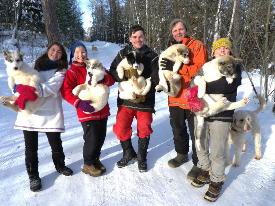 Paul and Susan Schurke launched Wintergreen Dogsled Lodge in Ely, Minnesota, in the late 1980s. Since then, climate change has caused them to cut down their winter season. The Schurke family (left to right: Berit, Susan, Peter, Paul and Bria) hold Canadian Inuit dogs.