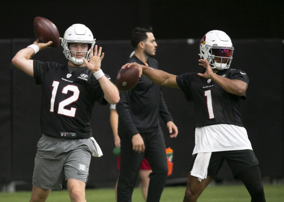 Cardinals quarterbacks Colt McCoy, left, and Kyler Murray pass during Cardinals training camp at State Farm Stadium in Glendale on July 30, 2021.