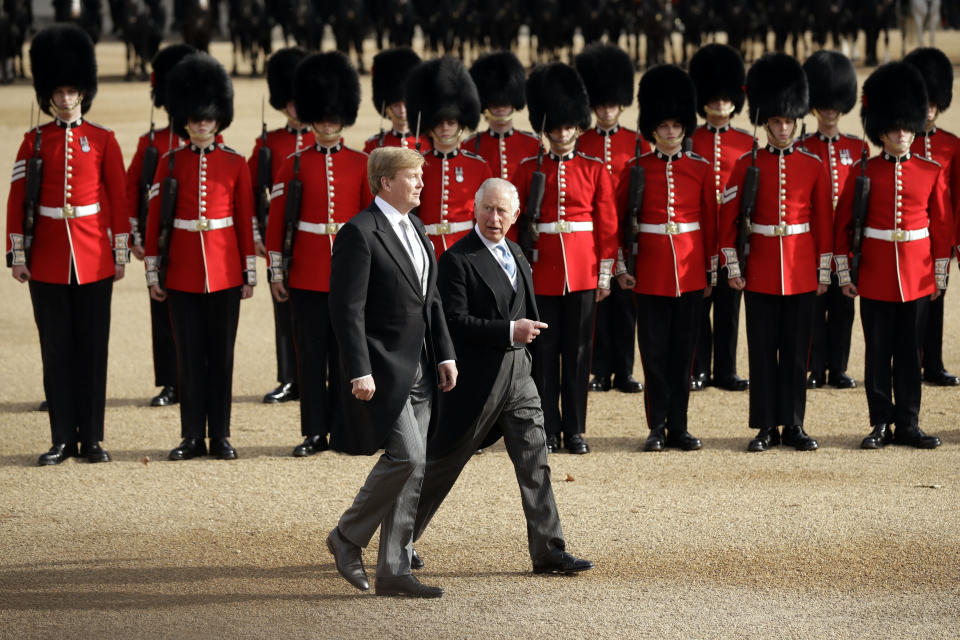 Netherlands' King Willem-Alexander, left, walks with Britain's Prince Charles after inspecting an honour guard during a Ceremonial Welcome on Horse Guards Parade in London, Tuesday, Oct. 23, 2018. Dutch King Willem-Alexander and Queen Maxima are on a State Visit to Britain. (AP Photo/Matt Dunham, Pool)